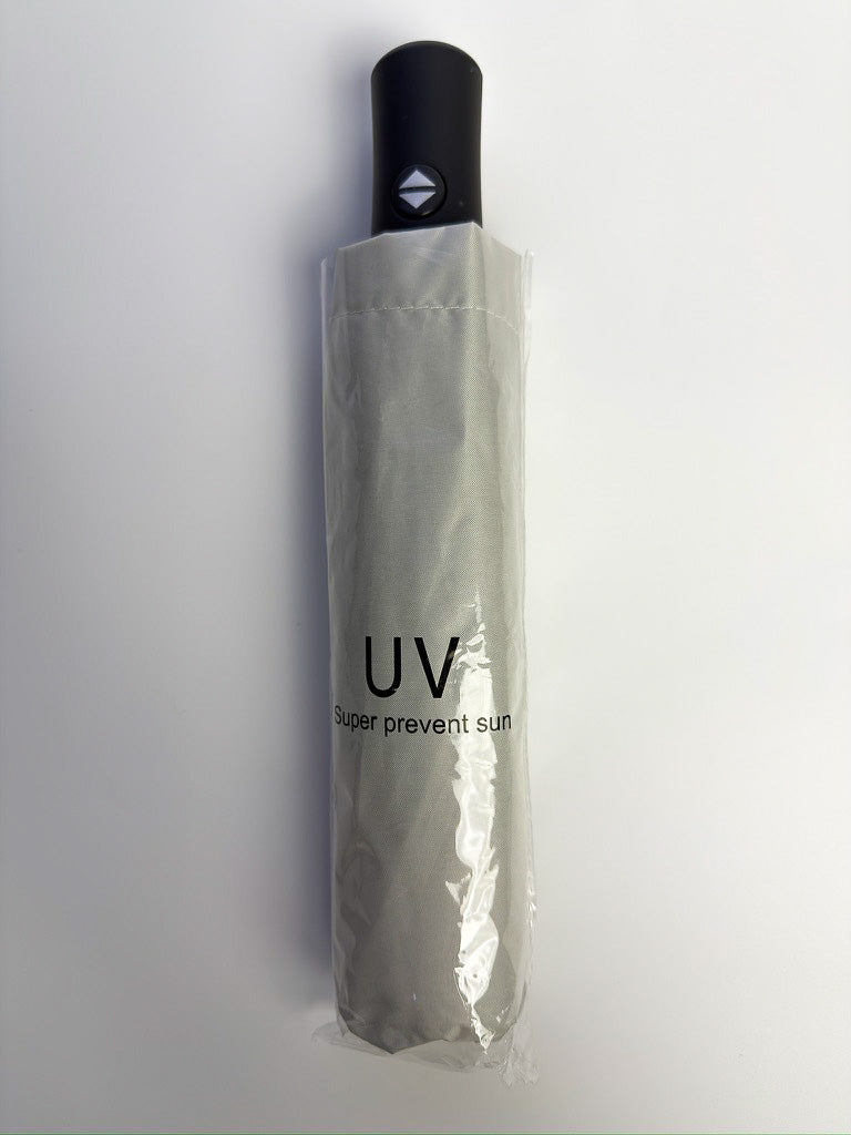 Parapluie anti-UV beige, format compact replié, à glisser dans un sac